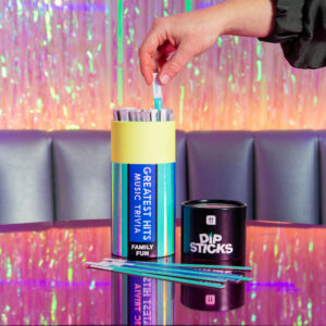 Hand reaching into Greatest Hits Music Trivia Dipsticks