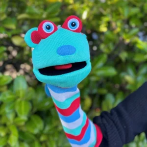 Hope sockette on a hand in front of green bushes